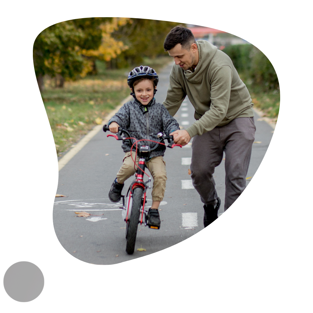 Father teaching son to ride a bicycle