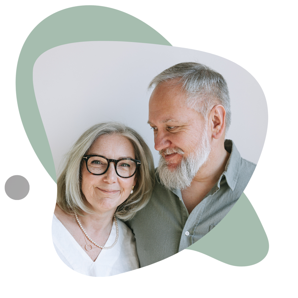 Two people standing next to each other in front of a white background